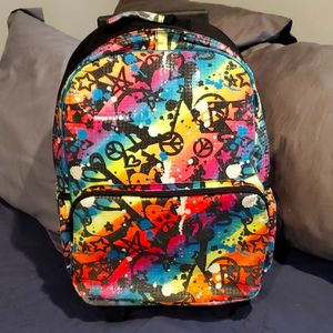 Justice rolling backpack with handle with graffiti design. Worn but rolls good.